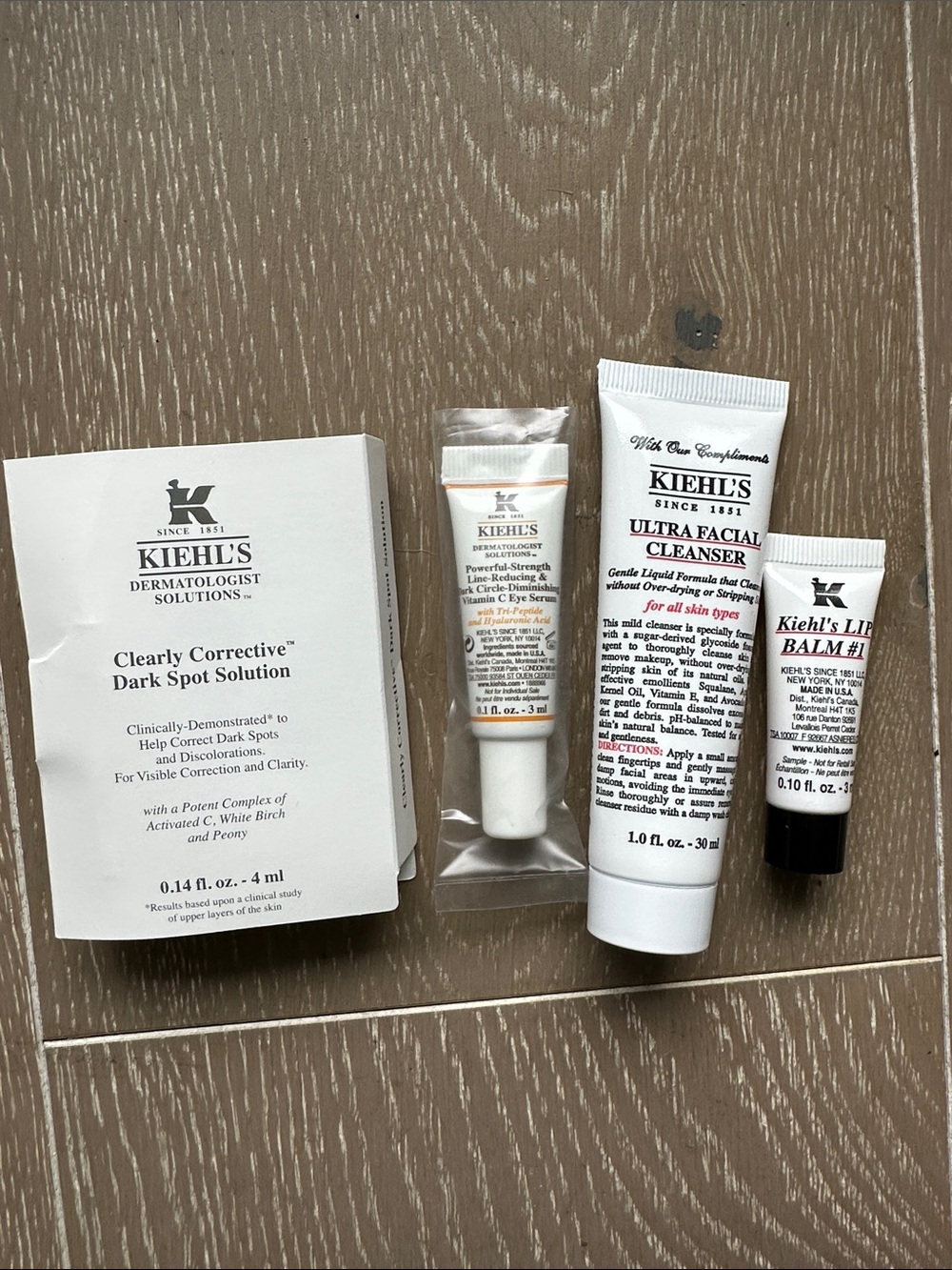 Kiehl's Travel Skincare dark spot solution, eye serum, facial cleanser, lip balm